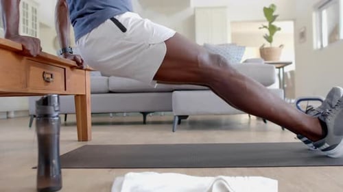 Muscular Man Does Tricep Dips on Table