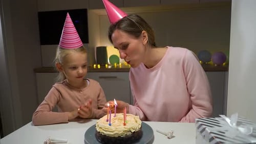Woman and Child Celebrate Birthday with Cake