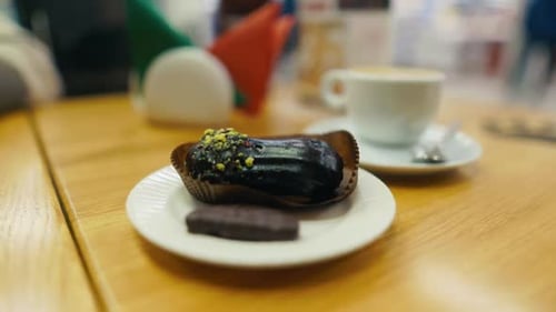 Chocolate Eclair and Coffee Still Life