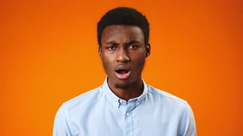 Man Shows Many Emotions On Orange Background
