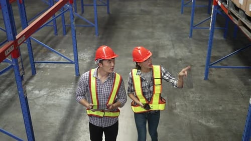 Blue collar workers working at warehouse.