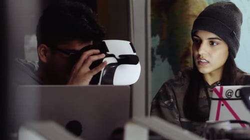 Friends using VR headset and working on tech