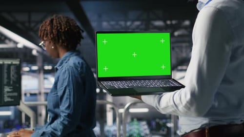 Close Up of Data Center Admins on Industrial Platform Using Green Screen Laptop