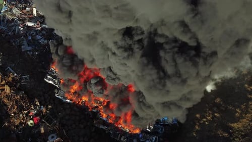 Fire Huge Fire at a Car Junkyard Black Smoke Pollutes the Atmosphere Ecological Disaster Global