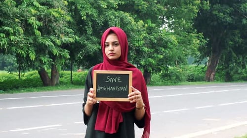 Kolkata, India: Stay home message for corona virus covid-19. Girl is holding banner. Social message.