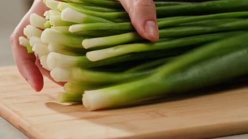 Cutting Fresh Green Onions on a Cutting Board Close Up Chef Cooking Green Vegan Salad