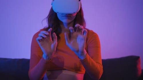Woman Using Virtual Reality Headset in Blue Purple Room