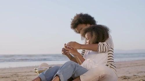Caring Parent and Child Enjoying a Beach Picnic