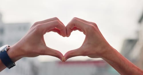 Hands Making Heart Shape in Urban Setting