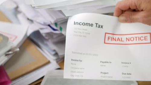 Close up of a man opening debt letters. The letter shows an income tax bill final notice