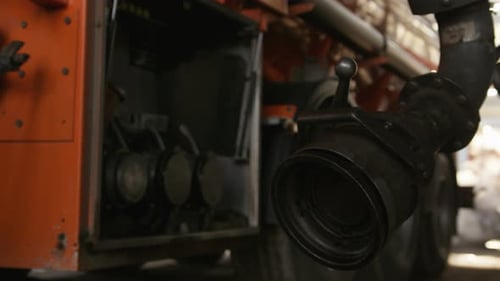 Worker Fills Fuel Truck with Steel Pipe Equipment