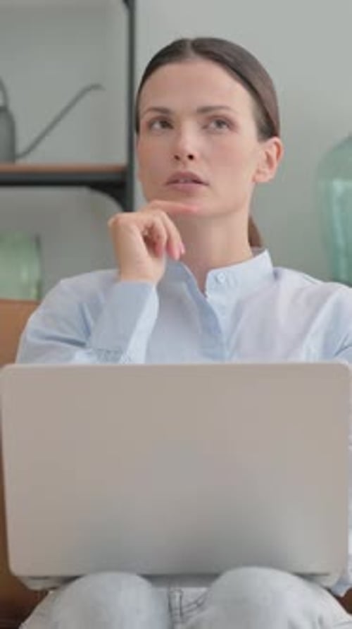 Woman Thinks and Starts Typing on Laptop Indoors
