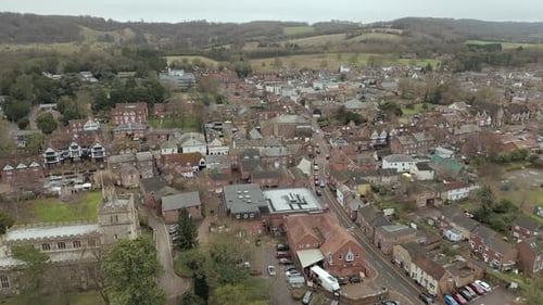 An aerial view of Tring village in Hertfordshire, England, on an overcast winter day. Flying left to