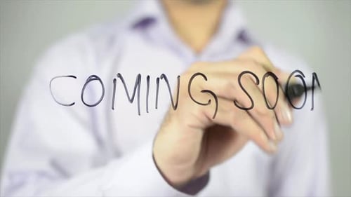 Man Writes Coming Soon on Clear Glass