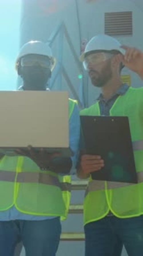 Professional Team Conducting Detailed Inspection of Turbines in Renewable Energy Field Ensuring