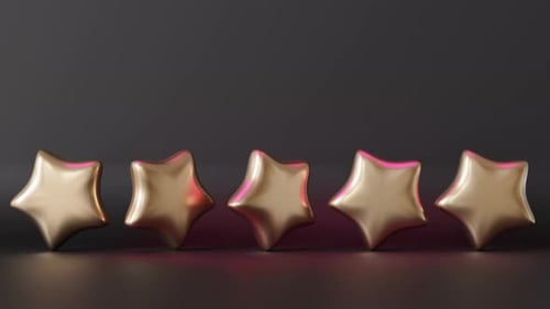 Five golden stars on black background with copy space for text.