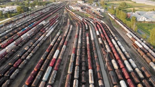 Aerial shot Showing Large Train Depot With Many colorful cargo Trains