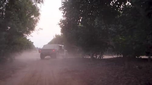 Israeli Army armored vehicles drive on a sandy road during an IDF military operation in the Golan.