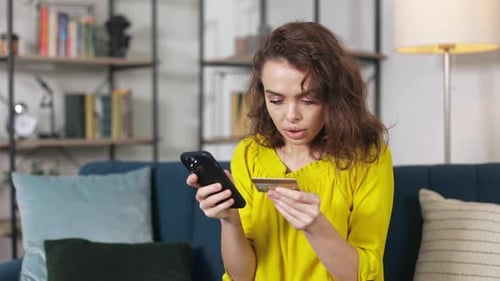 Woman Enjoying Online Shopping with Bank Card and Smartphone