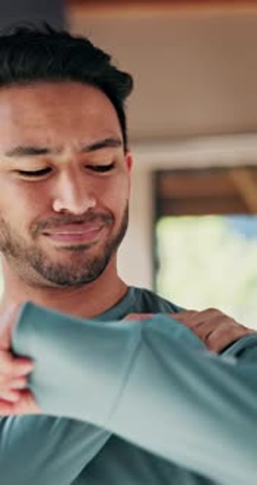 Young Adult Massages Sore Shoulder