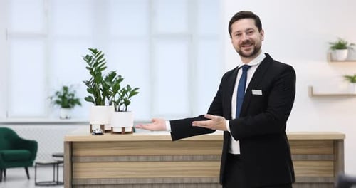 Receptionist welcoming near reception desk in hotel