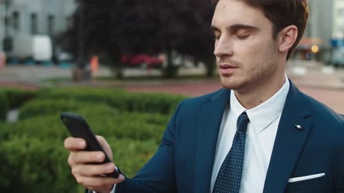 Portrait of Successful Business Man, Writing Message on Smartphone in City Walk