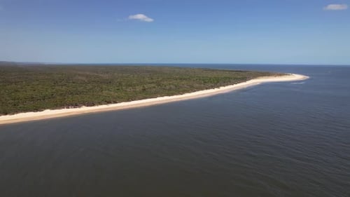 Forested Inskip Peninsula With Sandy Beach On Sunny Day In Queensland, Australia. wide aerial shot