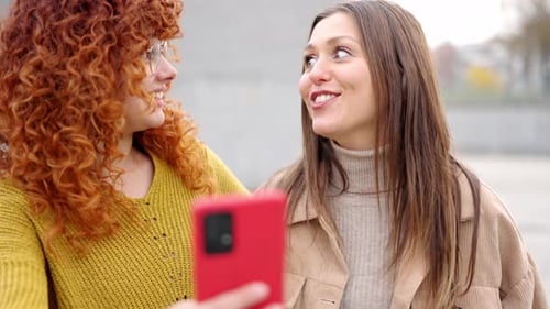 Young Women Enjoying Time Together With Cellphone