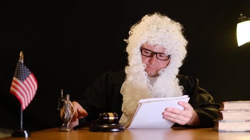 Man in Wig Holds Gavel and Reads Papers