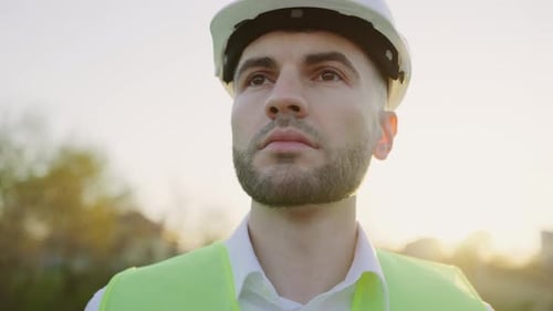 Handsome Builder in Special Safety Uniform Looking Away While Standing Outside