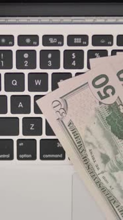Top View of Dollars on Keybord of Laptop, Business Concept, Vertical Video