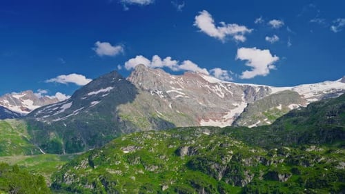 The Swiss Alps in Summer are an Incredible Natural Landscape with Clouds Hanging Over the Mountains