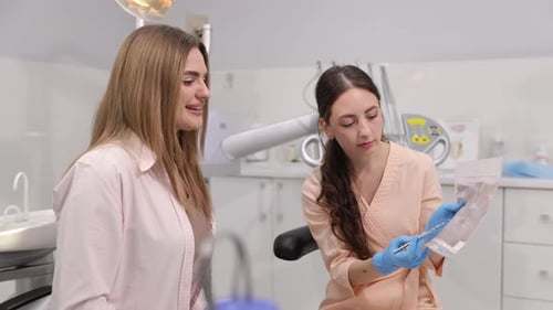 Dentist Explaining Dental Care Procedures to Patient in Welcoming Clinic Ensuring Understanding and