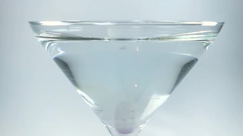 Close-up Martini Glass Filling with Clear Liquid