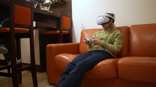 Woman playing video games with VR headset