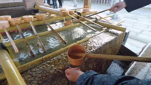 Girl Washing Hands at a Japanese Temple
