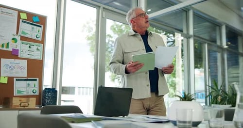 Man Reviews Data in Modern Office