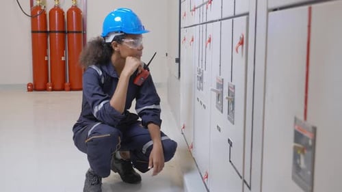 Electrical Worker Communicating with Walkie-Talkie