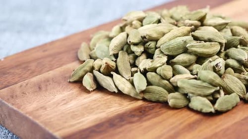 Close Up of Cardamom on Chopping Board on Table