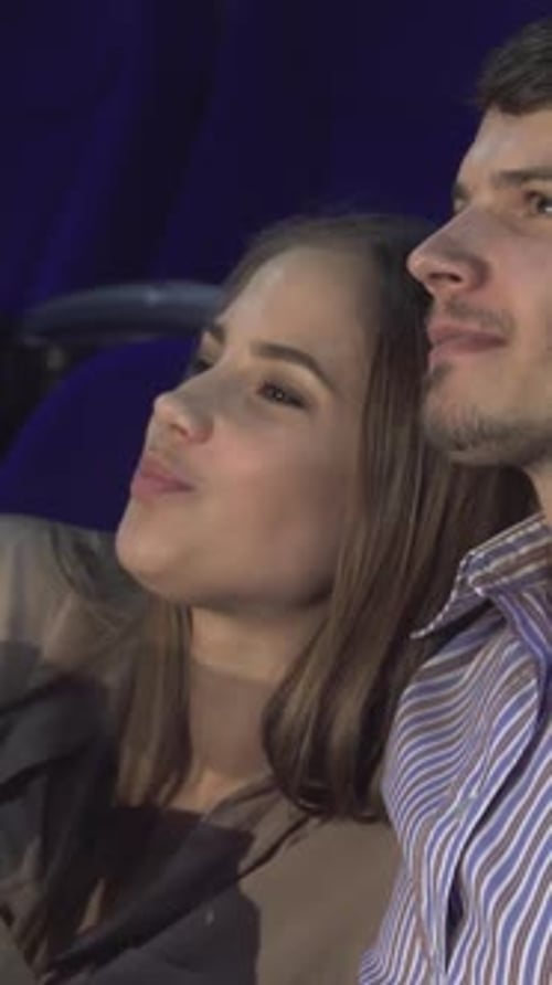Joyful Couple Sharing Laughter at a Romantic Comedy in the Cinema