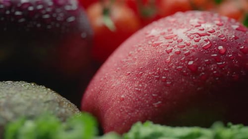 Red apple covered in water drops