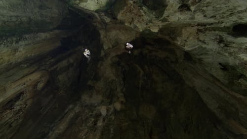 large cave interior with natural light coming through openings in the ceiling