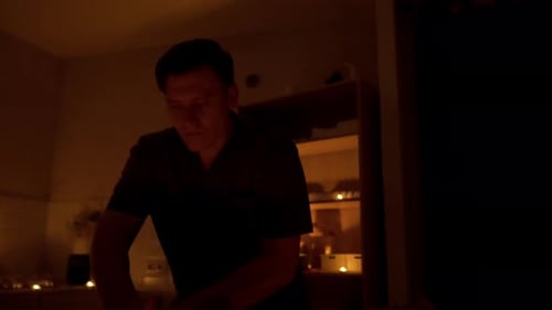 Massage in the Spa Salon A Man Lies on His Back and Rests in the Middle of the Candles