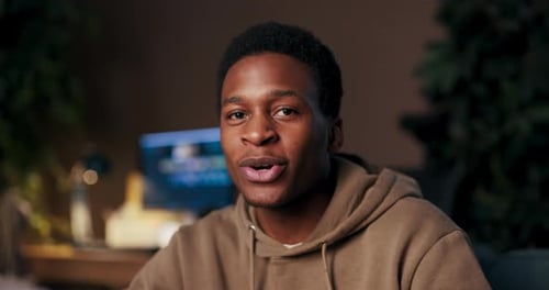 Young Adult Communicating to Camera Indoors