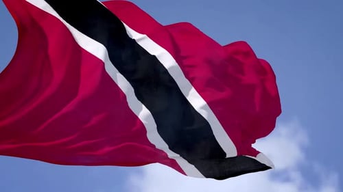 Trinidad and Tobago Flag Waving Against Blue Sky