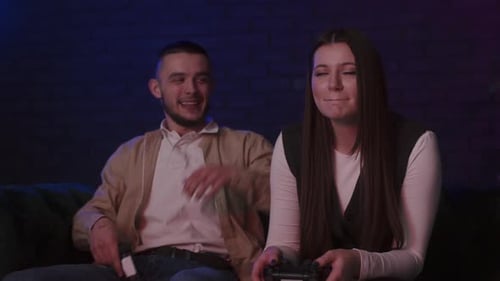 Man and Woman Play Video Games at Home