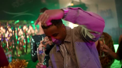 Group Celebrates with Champagne and Dances at Party