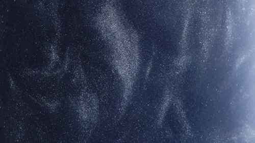 Abstract Glittering Particles Floating on Dark Blue Waves
