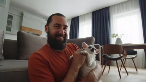 Man with Dog Smiling in Living Room