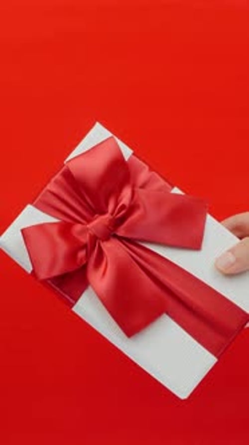 Gift Box with Red Ribbon on Red Background